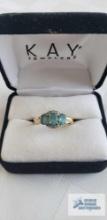 Gold colored three pale blue stones with clear gemstones on criss cross band, marked 14K, total