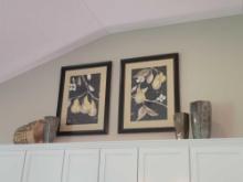 Contents above stove cabinets, pear themed prints, vases and wire frame bushel basket